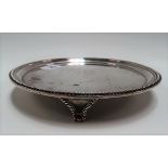 George III silver card tray of plain form with beaded rim and raised on triple beaded feet, later