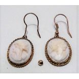 A pair of gold mounted white coral cameo pendant earrings