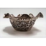 Indian silver embossed and chased frilled rim small bowl, the sides decorated with animals and an