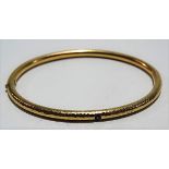Contemporary 14ct gold sapphire set bangle with planished finish, stamped 585, weight 11g approx.