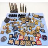 Collection of military badges, deactivated bullets, military buttons etc