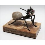 Contemporary white metal and fossilised sea anemone modelled as an ant with coral set eyes, upon