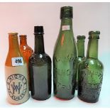 Collection of six beer bottles, one in stoneware and printed Hicks, St. Austell; five glass bottles,