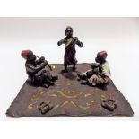 Austrian cold painted bronze Bergmann style group modelled as three Arab musicians upon a carpet,