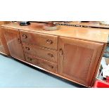 Ercol pale elm sideboard with three drawers flanked by two cupboard doors, width 155cm.