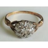 Early 20th Century rose gold diamond cluster ring (central stone is paste), set with seven