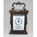 Ornately cast silver miniature carriage timepiece, the 1.5in white enamel dial with Roman Numerals