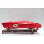 Vintage pond speedboat with engine, red painted upon stand, length 85cm