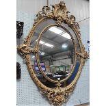 Impressive 19th Century carved wood and gesso parcel gilt and cream painted oval wall mirror, with