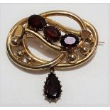 9ct gold four stone garnet set open work brooch, stamped 9ct, weight 15.5g approx.