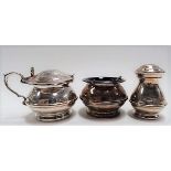 Modern silver three-piece cruet of ovoid banded form, comprising pepper shaker, salt and hinge