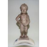 Sitzendorf porcelain figure of the statue 'Manneken Pis' upon an arch, height 21cm.