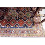 Eastern wool hand knotted rug with three columns of lozenge medallions with flowerheads and birds
