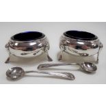 Pair of Victorian silver circular salts with blue glass liners and pair of salt spoons, the ovoid