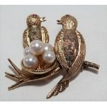 14ct gold pearl and ruby set novelty brooch modelled as two birds with ruby eyes and a pearl egg