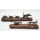 Two novelty white metal animal groups on wood, one modelled as a warthog with three piglets, the