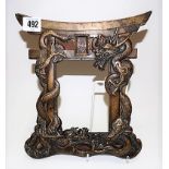 20th Century Chinese bronze photograph frame cast with coiled dragons wrapped around an arch upon