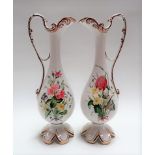 Pair of 19th Century porcelain foliate painted pedestal slender jugs with scroll loop handles and