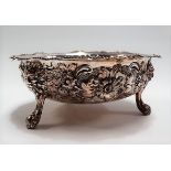 Victorian silver bowl, flower head embossed and chased raised on triple feet with bearded masks,