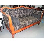 Biedermeier settee, the shaped top over outswept arms with upholstered back, seat and arms raised on