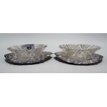 Pair of Victorian silver and cut glass lunette form salts, the cut glass salt cellar upon a