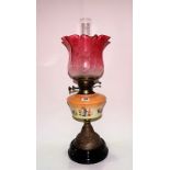 Brass and porcelain oil lamp with blush cranberry glass flower etched shade and on black pottery