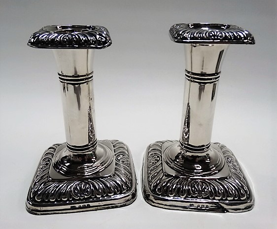 Pair of Edwardian silver candlesticks by Ellis Jacob Greenberg, with gadrooned square section sconce