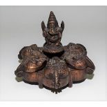 Indian brass spice box of circular section and with hinged lid each cast with Ganesh and with Ganesh