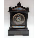 Black slate and pottery inset two-train mantel clock with French movement striking on a gong, height