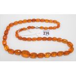 Amber graduated oval faceted bead necklace, with rose gold clasp, length 72cm, weight 43.2g approx.