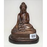 Burmese bronze model of Buddha with glass inset eyes and hairpiece upon a wooden stand, height