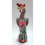 Chinese famille rose porcelain figure of a phoenix bird upon a naturalistic foliate base, height