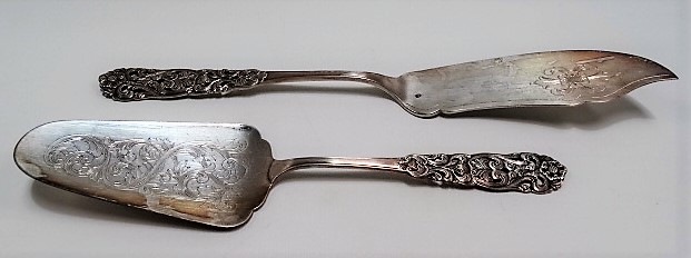 Continental white metal slice and server with foliate scroll cast and pierced handles, maker NM,