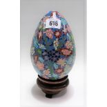 Chinese cloisonné egg upon stand, height overall 20cm