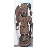 Large Benin tribal bronze standing figure holding a staff and club and wearing a leopard head