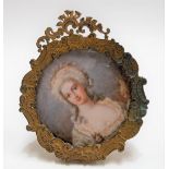 Early 20th Century watercolour miniature on ivory of an 18th Century young woman in wig, circular,