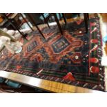 Eastern wool hand knotted rug with three central medallions within geometric designs and borders,