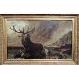 Early 20th Century oil on canvas depicting a stag and two hounds in a lake landscape, 75cm x 125cm.