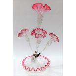 Victorian cranberry and clear glass four branch epergne upon a circular frilled base, height 53cm.