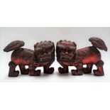 Pair of Burmese carved wood lacquered opposing Fo dogs, width 25cm