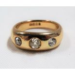 18ct gold gentleman's gypsy set three stone diamond ring, the central diamond of 0.50ct spread