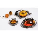 Three silver mounted 'amber' style brooches together with a pair of 'amber' style drop earrings (4)