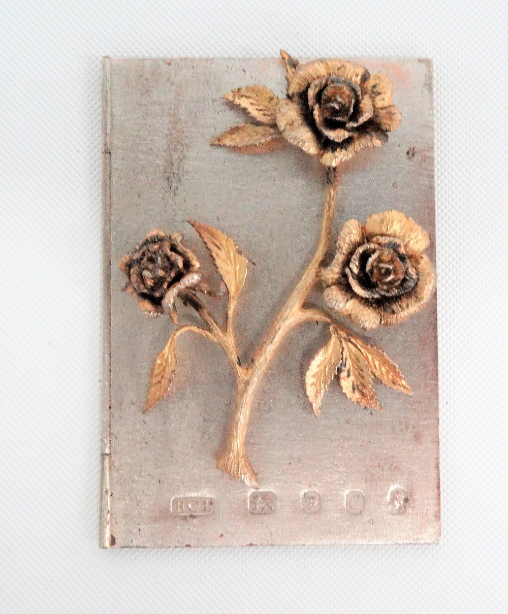 Contemporary silver and silver gilt hinged 'card', the front with applied cast and chased three