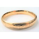 Yellow metal foliate engraved bangle (test 9ct), weight 15.7g approx