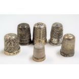 Six silver thimbles