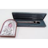 Silver engine turned handled bottle opener within fitted case together with a silver front religious