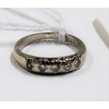 White metal, possibly platinum five stone diamond set ring, the diamonds of 0.07ct spread approx (