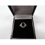 18ct gold, diamond and sapphire cluster ring, the oval sapphire of 0.30ct spread approx and