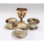 Three silver hallmarked napkin rings; together with an egg cup, weight 1.85oz approx (4).