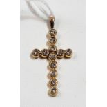 Gold and diamond twelve stone cross pendant, the diamonds of 0.07ct spread approx, within collet
